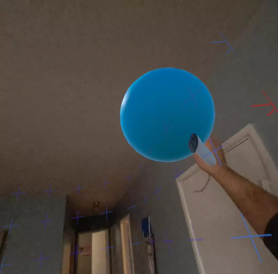 A blue sphere in a dining room with VR boundary lines